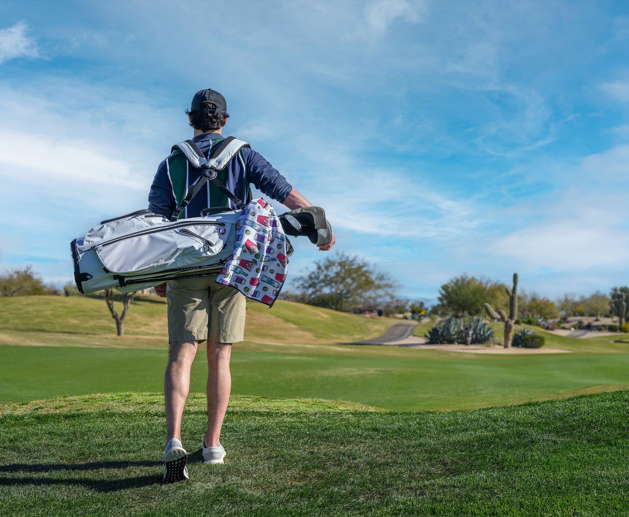 Transfusion golf towel hanging from golf bag on golf course