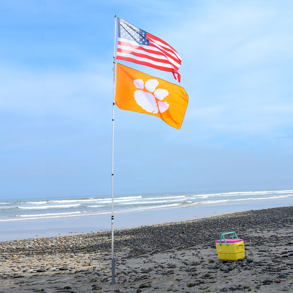 20 foot flag pole kit with two flags on beach