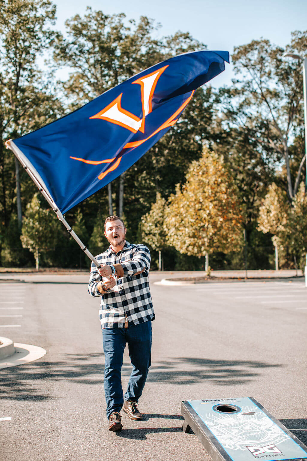 man waving small flagpole