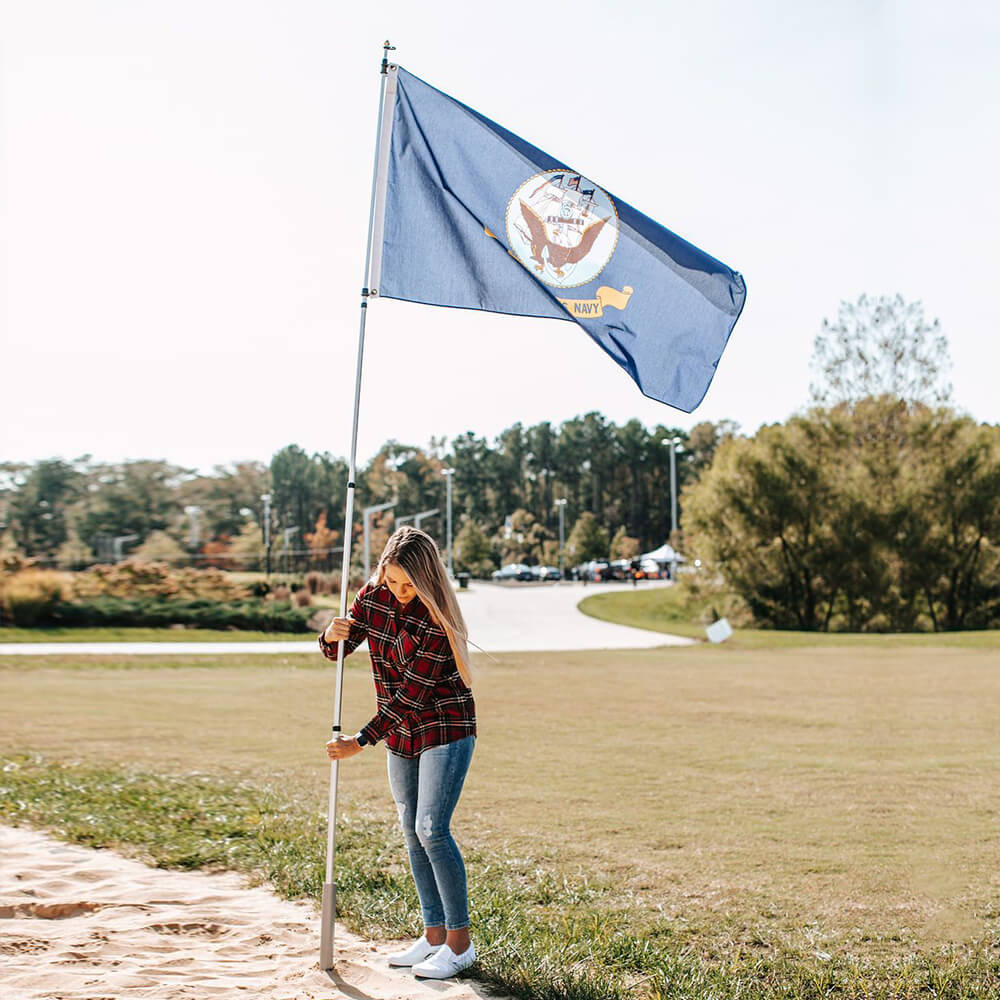 woman flying us navy flag