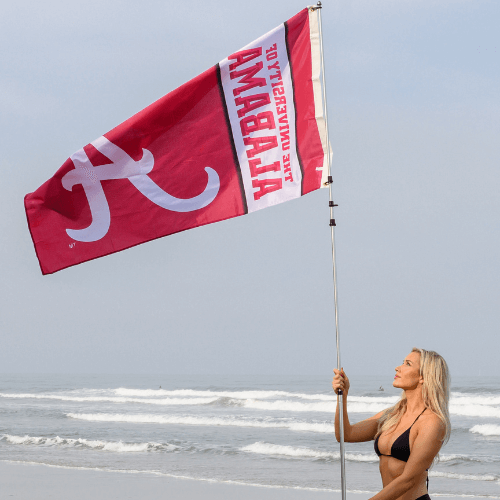 woman holding alabama football flag